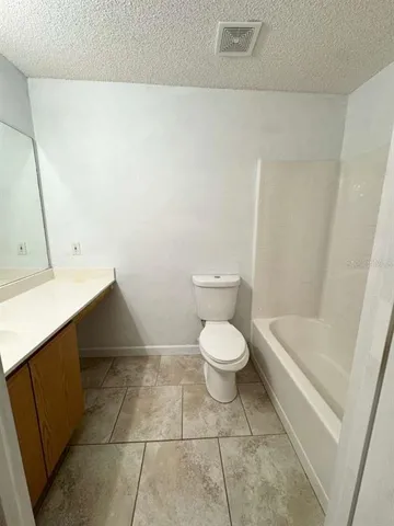 a bathroom with a bathtub and a toilet