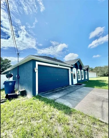 a front view of house with yard and trees