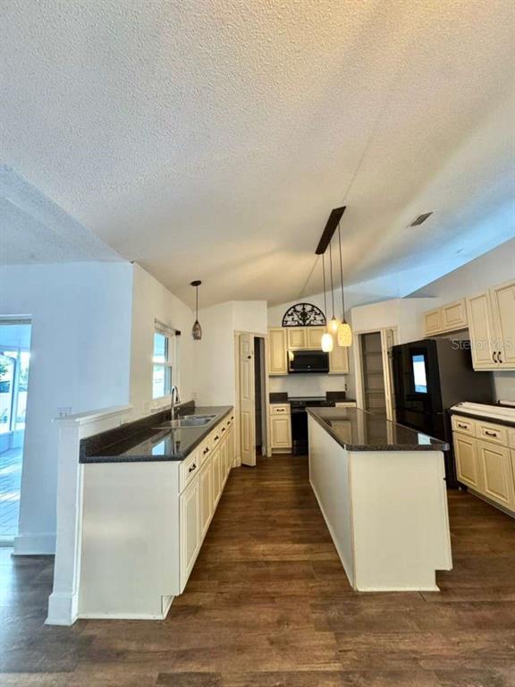 7132 Landmark Drive Spring Hill, FL 34606 - Photo 6 of 14 a large kitchen with stainless steel appliances a large counter top and a wooden floors