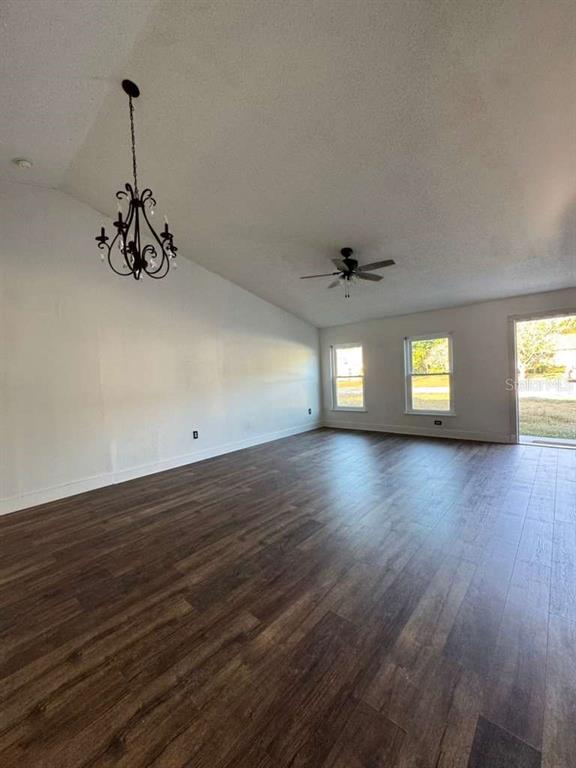7132 Landmark Drive Spring Hill, FL 34606 - Photo 8 of 14 an empty room with wooden floor and windows