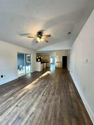 a view of empty room with a window and fireplace