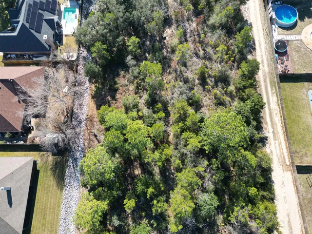 an aerial view of residential house with outdoor space and swimming pool