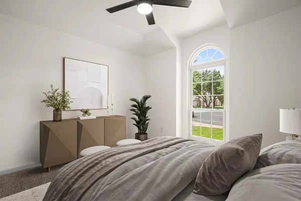a bedroom with a bed and a potted plant