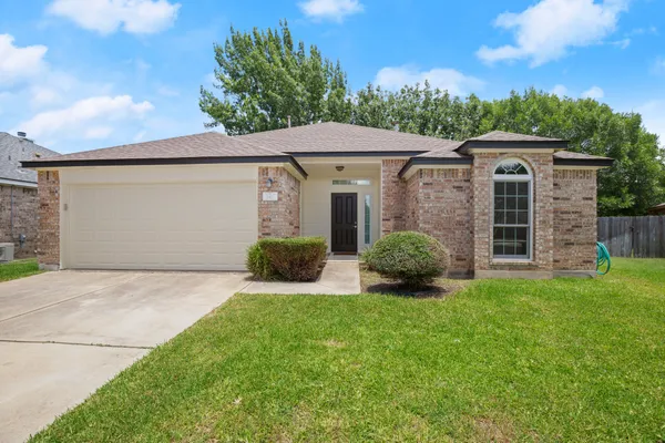 a front view of a house with a yard