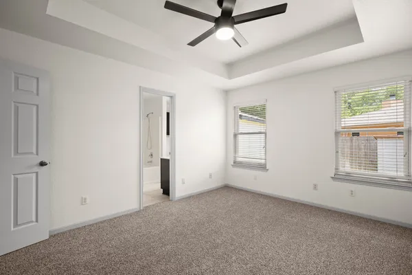 a view of a livingroom with a ceiling fan and window