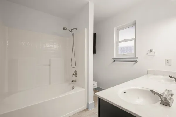 a bathroom with a bathtub and a sink