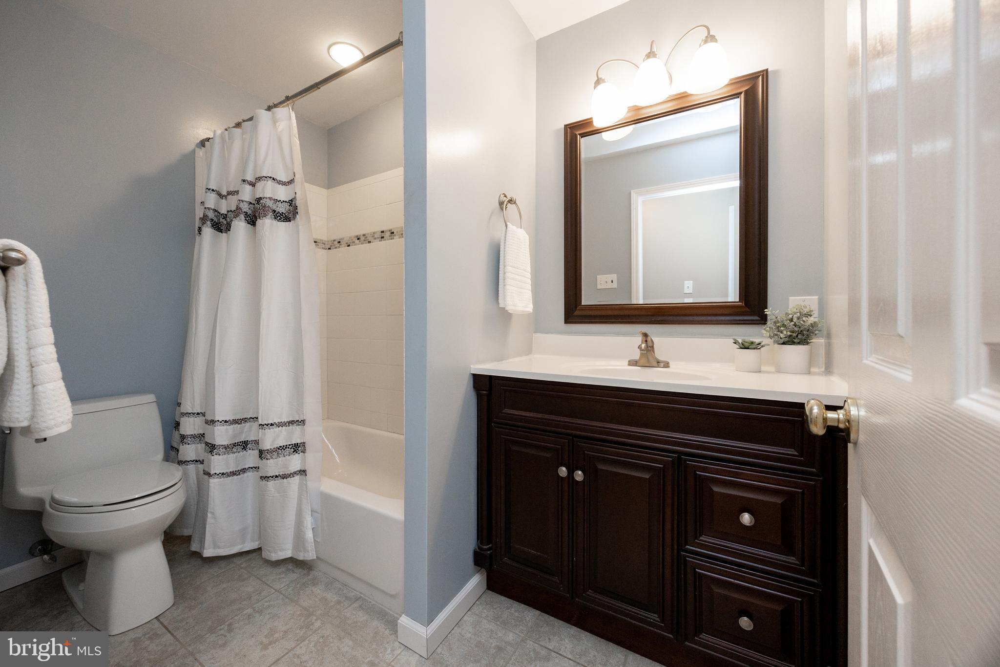 402 Concord Avenue Exton, PA 19341 - Photo 25 of 39 a bathroom with a toilet a sink and a mirror