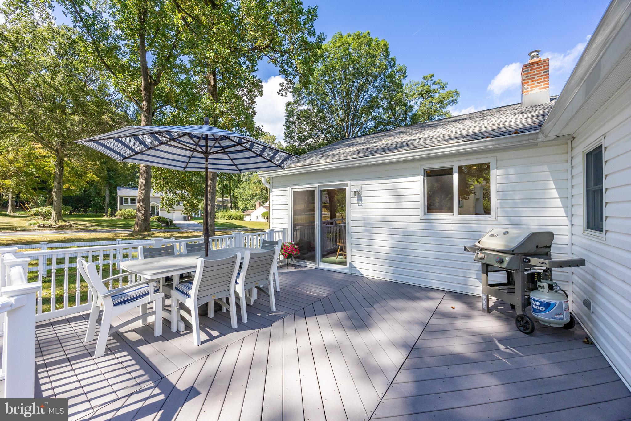 402 Concord Avenue Exton, PA 19341 - Photo 37 of 39 a view of a patio with table and chairs with wooden floor and fence