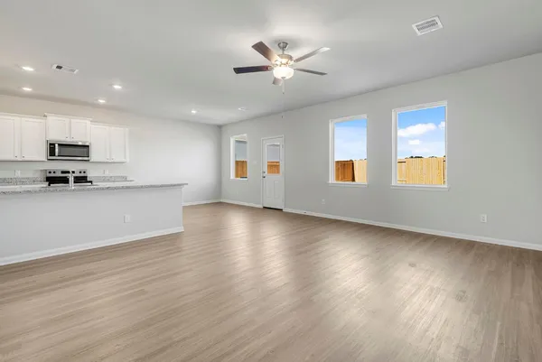 a view of a livingroom with furniture wooden floor and a window