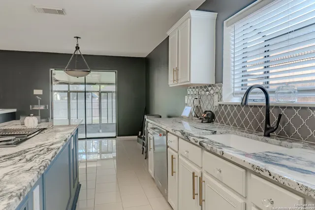 a kitchen with a sink stove and cabinets
