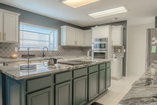a kitchen with a sink stove and cabinets