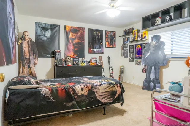 a living room with furniture and a ceiling fan