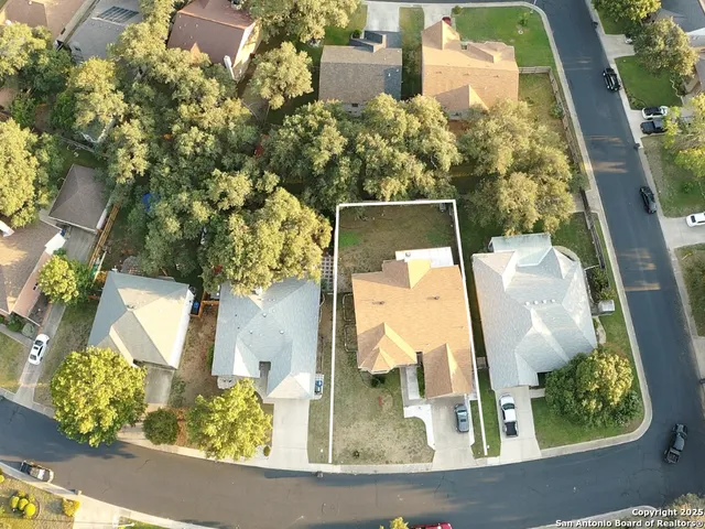 an aerial view of a house with a swimming pool