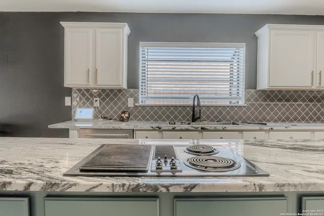 a kitchen with a sink and a stove