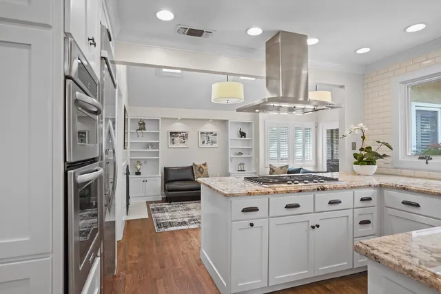 a spacious bathroom with a granite countertop sink and a large mirror
