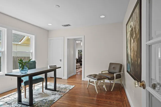 a bathroom with a granite countertop toilet a sink a mirror a bathtub and vanity