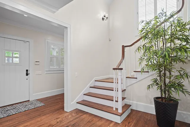 a view of entryway with wooden floor and front door