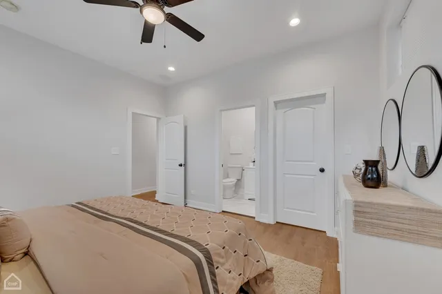 a bedroom with a bed and a chandelier