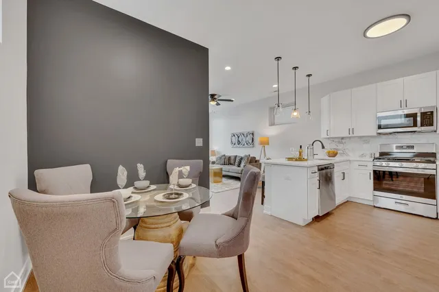 a view of a dining room with furniture and wooden floor