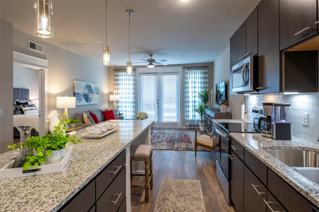 a kitchen with sink stove and cabinets
