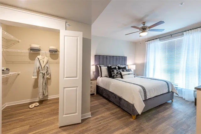 a bed room with a bed and a ceiling fan