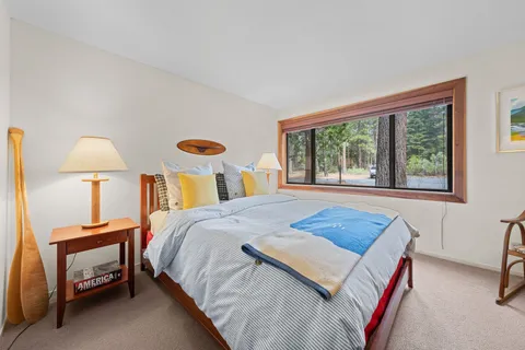 a bedroom with a bed and a lamp