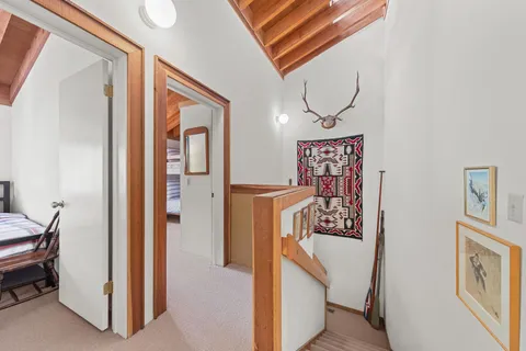a view of a hallway with paintings on the wall