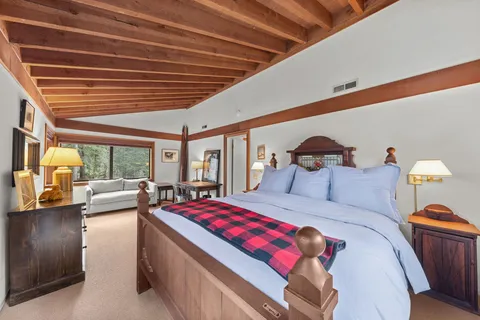 a bedroom with furniture and a large window
