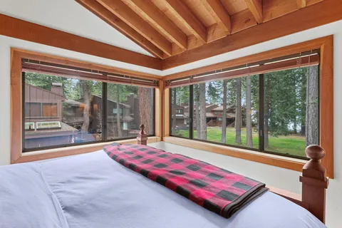 a room with pool table and windows