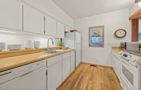 a kitchen with a sink and a stove top oven