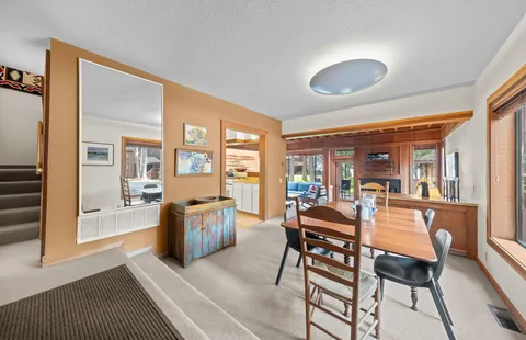 a dining room with furniture and wooden floor