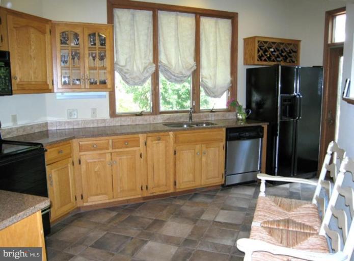 2809 Ridge Rd Drive Alexandria, VA 22302 - Photo 13 of 19 a kitchen with stainless steel appliances granite countertop a refrigerator and sink