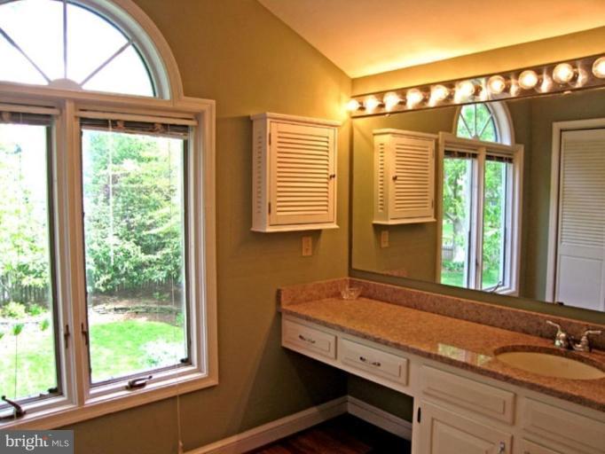 2809 Ridge Rd Drive Alexandria, VA 22302 - Photo 15 of 19 a bathroom with a sink a mirror and a window