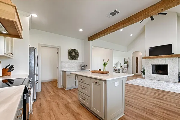 a kitchen with a stove a sink and a refrigerator