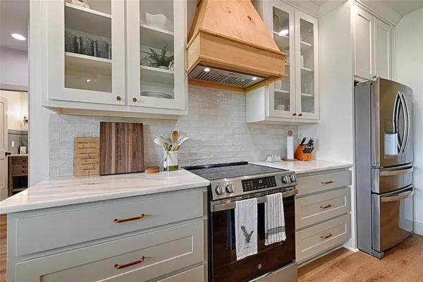 a kitchen with stainless steel appliances granite countertop a stove and a refrigerator