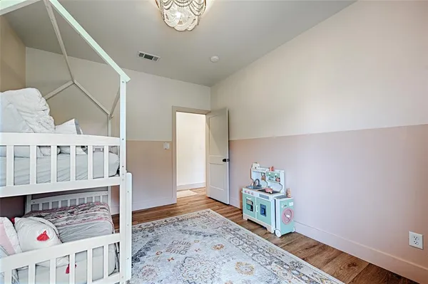 a living room with furniture and a baby crib