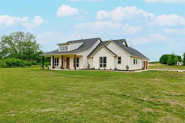 a front view of house with yard and green space