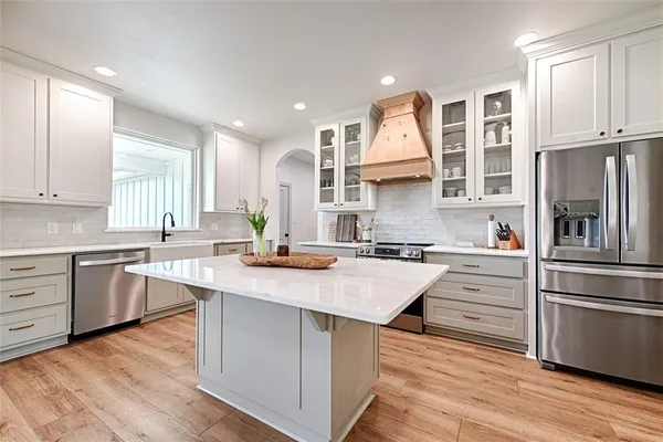 a kitchen with a sink stove and refrigerator