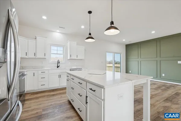 a kitchen with white cabinets and sink