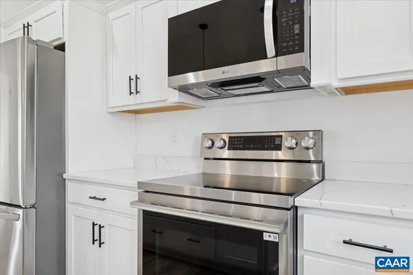 a stove top oven sitting inside of a kitchen