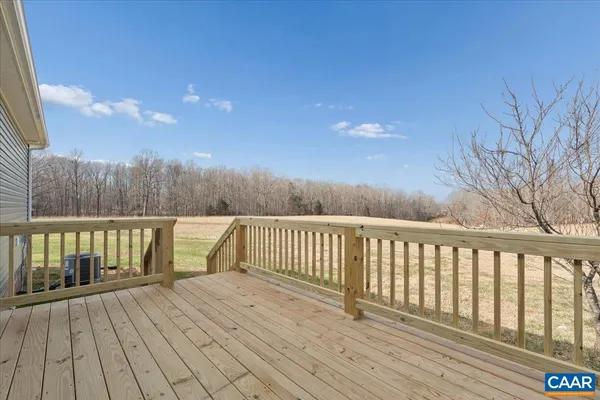 a balcony with wooden floor and fence