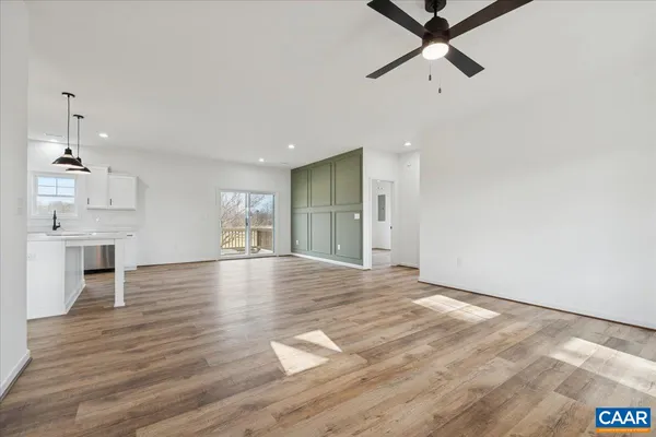 a view of empty room with wooden floor and window