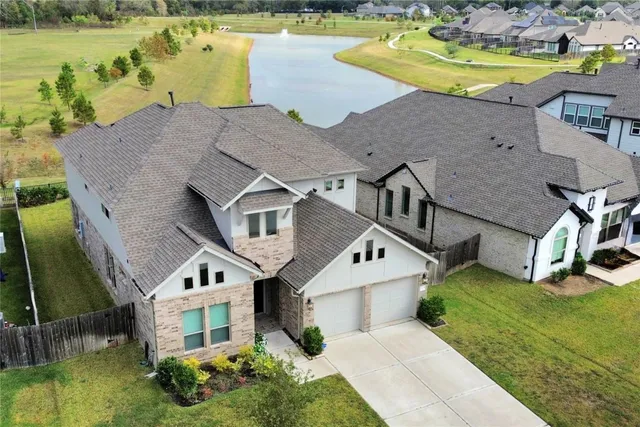 an aerial view of a house with a swimming pool