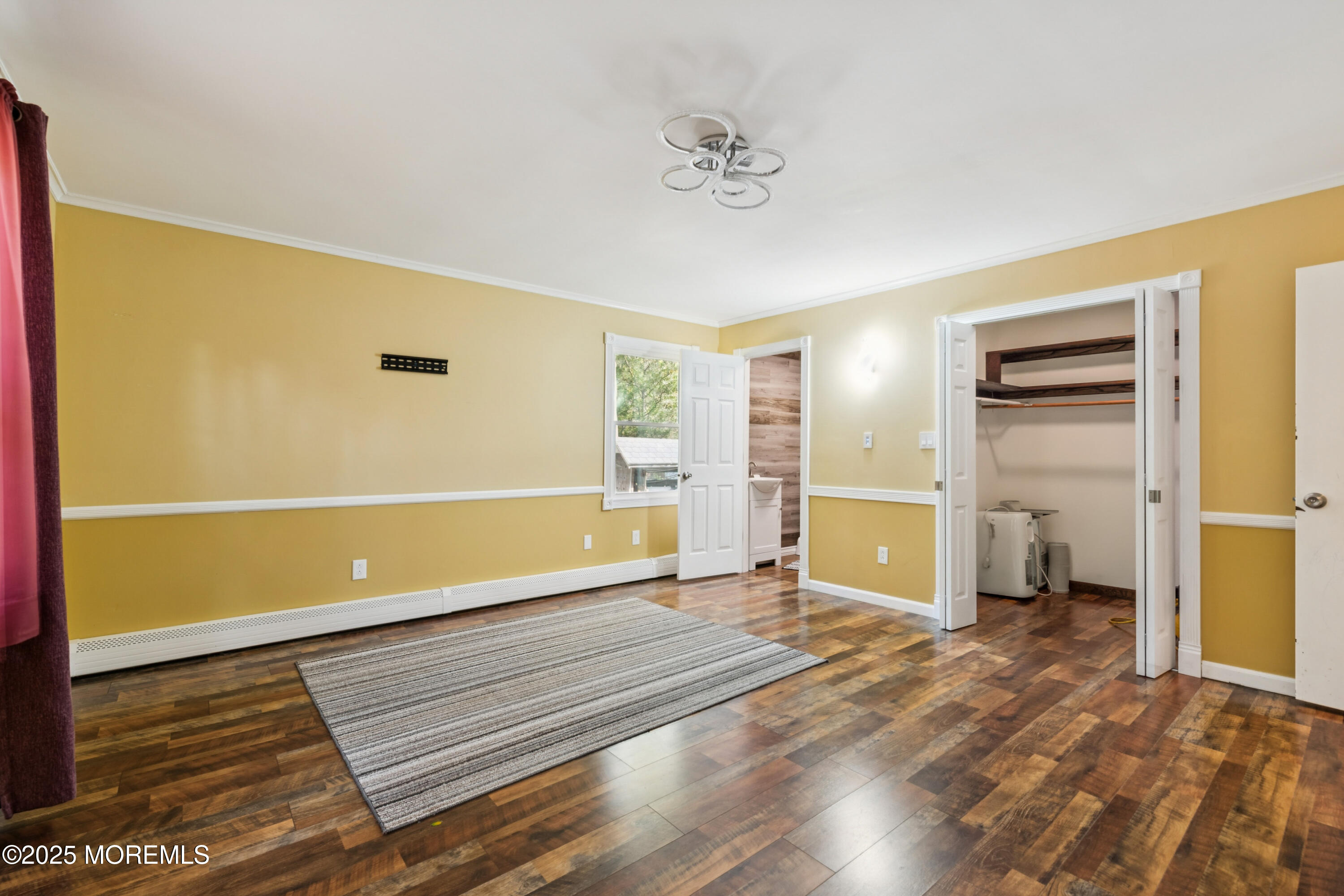 123 Georgia Road Freehold, NJ 07728 - Photo 13 of 25 a view of an empty room with wooden floor and a window
