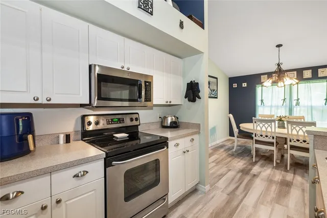 a kitchen with a stove a sink and a microwave