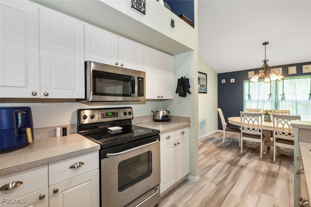 2005 Mc Arthur Avenue Alva, FL 33920 - Photo 11 of 32 a kitchen with a stove a sink and a microwave