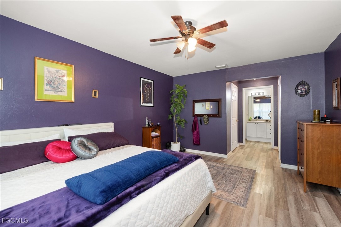 2005 Mc Arthur Avenue Alva, FL 33920 - Photo 15 of 32 a bedroom with a bed and a chandelier