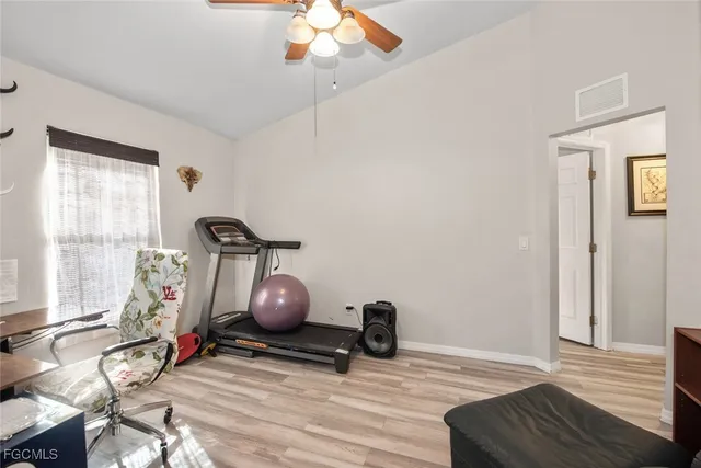 a view of room with wooden floor and windows