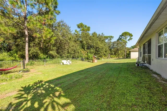 a view of yard with swimming pool and trees
