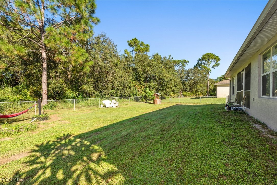 2005 Mc Arthur Avenue Alva, FL 33920 - Photo 30 of 32 a view of yard with swimming pool and trees